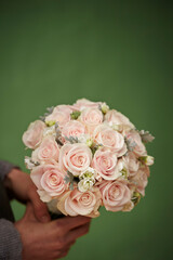 Wedding rose bouquet in hand