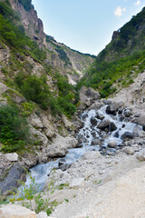 Large and small rivers and waterfalls in North Ossetia against the backdrop of majestic mountains. Republic of North Ossetia - Alania