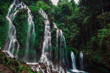 Fototapeta na wymiar Cascade waterfall in jungle in Indonesia