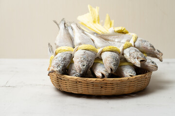 A salted yellow string of dried yellow corvina was placed in a bamboo basket.