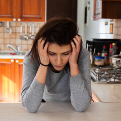 Sad tired young woman touching forehead having headache migraine or depression