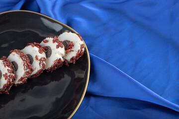 Close up photo of sliced sweet on black plate