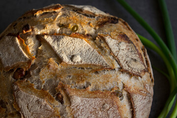Sourdough bread texture close up. Crusty bread with olives and nuts. Healthy eating concept. 