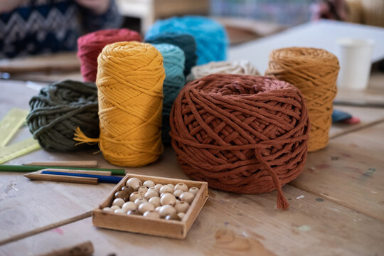 Tools and skeins of colorful threads for creating macrame with your own hands. Lesson, master class, training.