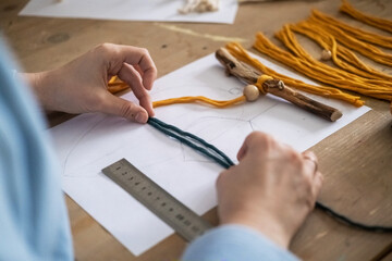Lesson, the process of creating macrame, weaving from threads. Hand made. A working space for...