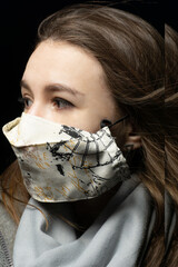 girl in a medical mask with a scarf on a black background