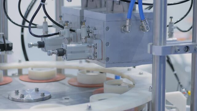 Automatic vacuum capping machine during work in demonstration mode at packaging exhibition, trade show - close up view. Manufacturing, industry, automated technology equipment concept