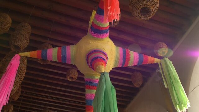 Colorful pinata and handmade lamps hanging from the ceiling