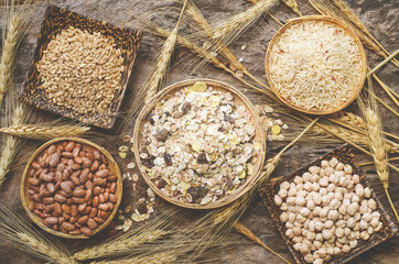 Top view of dry organic cereal and grain seeds consisted of barley, wheat, rice, and pearl barley seeds on sack fabric and grunge background in soft vintage tone