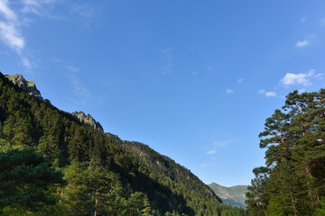 Beautiful mountain peaks of the North Caucasus against the backdrop of a blue cloudy sky. Republic of North Ossetia - Alania