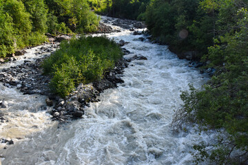 Large and small rivers and waterfalls in North Ossetia against the backdrop of majestic mountains. Republic of North Ossetia - Alania