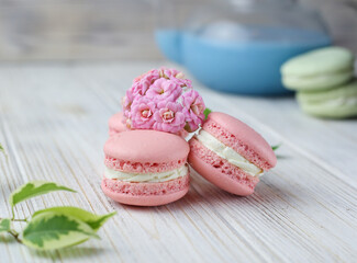 Pink macaroons with the glass pot of blue masala tea
