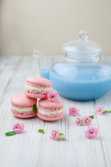 Pink macaroons with the glass pot of blue masala tea