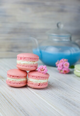 Pink macaroons with the glass pot of blue masala tea