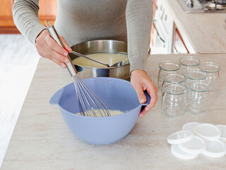 Woman making yogurt at home. Soy yogurt, vegan recipe. Cooking at home