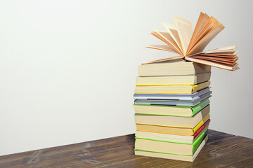 Stack of books on rustic table. Free space for text