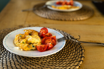 Omlette with Cheese and Parsley. Tomato as a Side