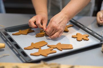the process of making gingerbread. baking holiday cookies at home. cookies of different shapes on a...
