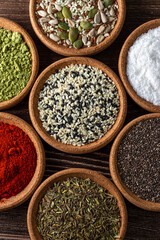Sesame, chia, pumpkin seeds in wooden bowls close up. Top of view and flat lay photography of herbs, spices and seeds.