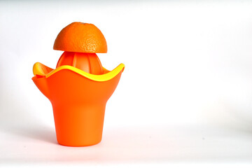 Manual juicer on a white table.