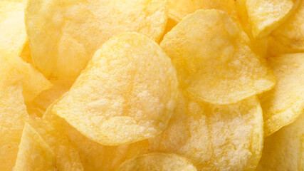 Potato chips pattern. Yellow salted potato chips as food background. Chips texture, studio photo,...