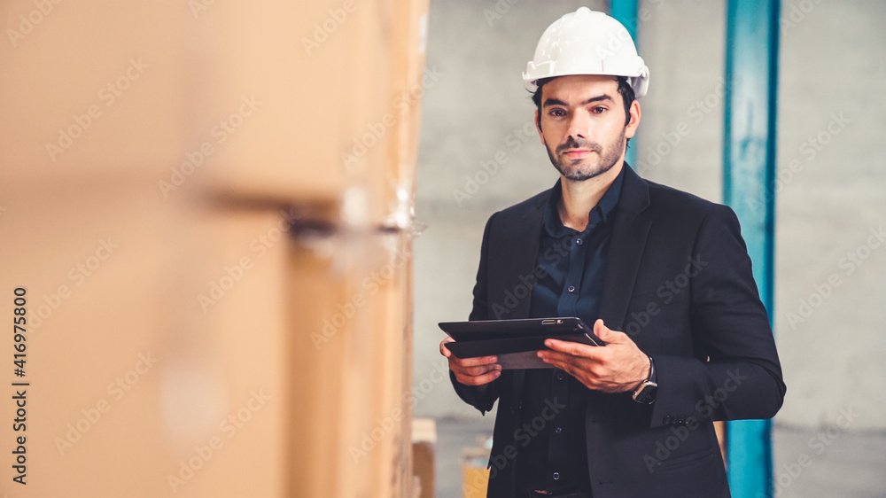 Poster factory manager using tablet computer in warehouse or factory . industry and supply chain management