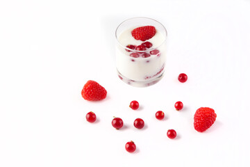 A healthy breakfast with light yoghurt and red fruit (raspberries and redberries) served in a glass
