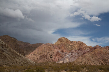 Fototapeta premium The arid desert and rocky sierra. View of the sand, sandstone and colorful rocky formation in Mendoza, Argentina. 