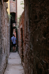People Walking in a Very Narrow Alley in Venice, Veneto, Italy