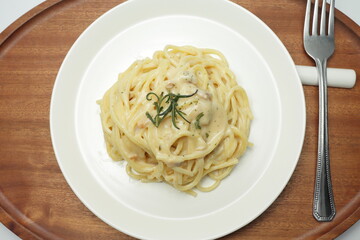 Carbonara spaghetti on a wood tray