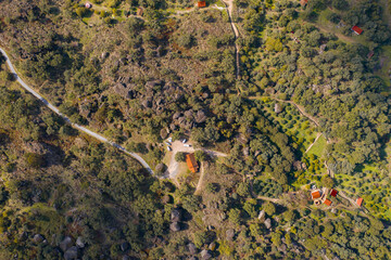 Drone aerial above top view of camper vans with solar panels on a nature green trees landscape in...