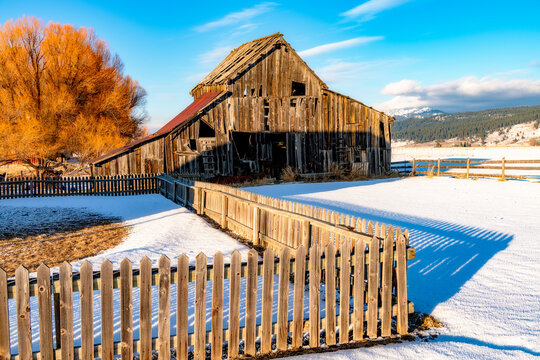 Artistic image of a barn in winter at sunset