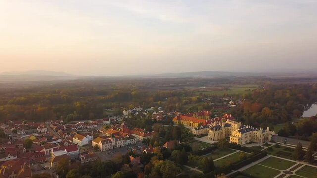Aerial view of small town Lednice and castle yard with green gardens in Moravia, Czech Republic. UNESCO World Heritage Site.