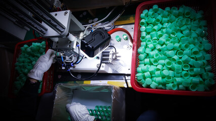 Packing and Assembleding of Plastic bottle caps, from the manufacturing department, In a plastic production factory.