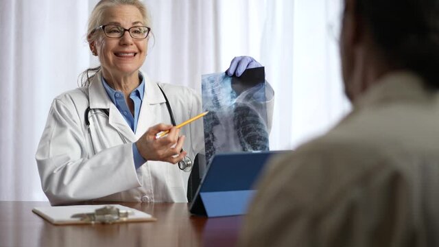Doctor is looks at X-ray image of patient. Slow motion concept of doctor for personal healthcare in office.