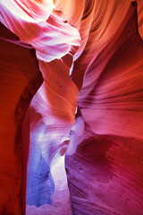 Beautiful red and orange sandstone wall with warm subtle light glow inside Antelope Canyon,...