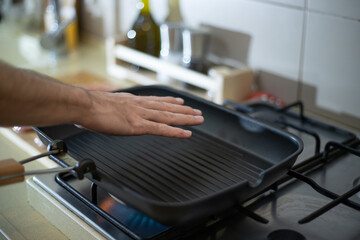 Cooking chicken breast. Man holds his hand over a preheated frying pan. Diy five. Step by step
