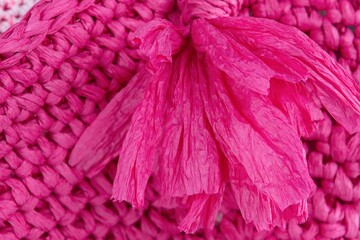 Handmade pink  raffia bag on grey background. Close-up. Wicker bag. Pink  wickerwork.