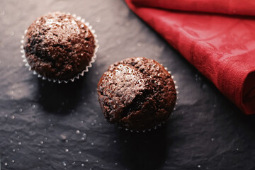 Two chocolate muffins freshly baked at home, homemade comfort food recipe
