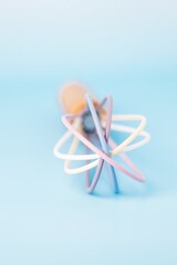 Colored plastic whisk for whipping on a blue background, copy space