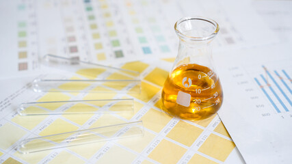 Flask and test tubes with urine on medical color schemes. The concept of laboratory analyzes, ph control.