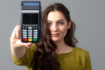 woman hold modern bank payment terminal to process acquire credit card payments, lifestyle concept