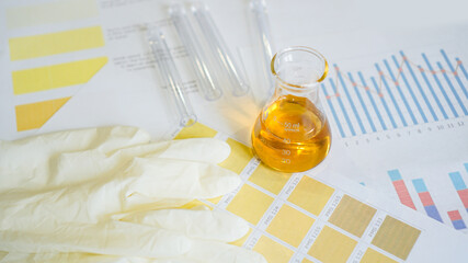 Urine test. Flask with analyzes on medical tables with color determination. White medical gloves.