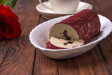 Eastern sweet halva with chocolate and rose powder on wooden background.
