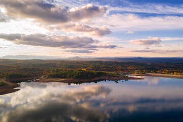 Drone aerial view of a lake reservoir of a dam with perfect reflection on the water of the sky in Sabugal, Portugal