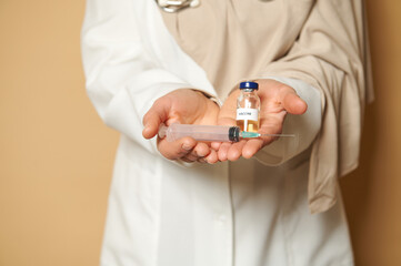 Unrecognizable doctor holds syringe and vaccine against infectious disease. Concept of immunization of the population and the preventive fight against infections.