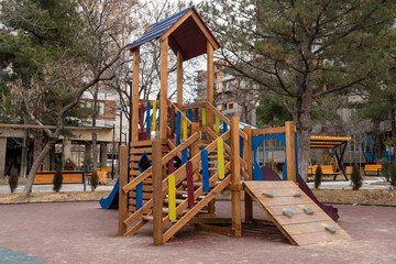 Fototapeta na wymiar Empty wooden playground in the park during coronavirus.