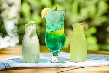 A milkshake and two lemonades on wooden table