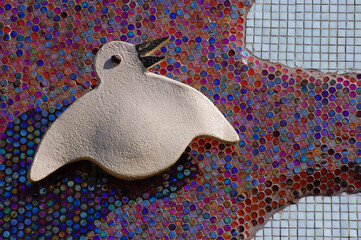 Abstract bird silhouette on mosaic wall background