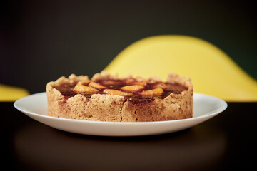 Organic homemade cake with fruits on the white plate.